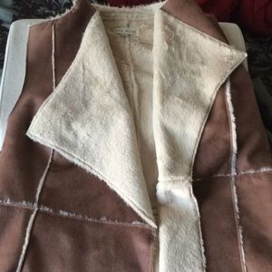 Tan and ivory faux hide vest with soft fur lining.